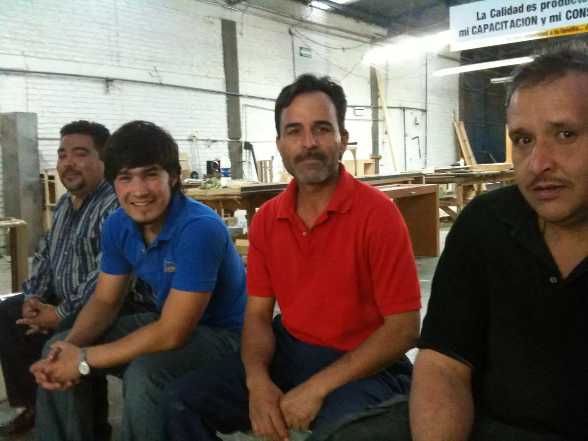 people inside furniture factory smiling